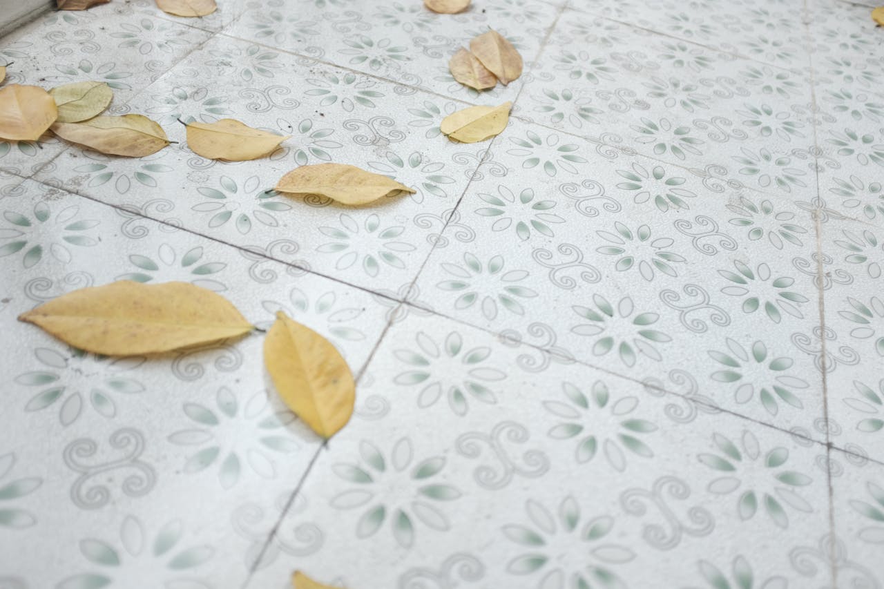 Decorative tiles adorned with autumn leaves scattered across the floor.